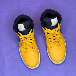 Yellow and black Jordan 1s mid